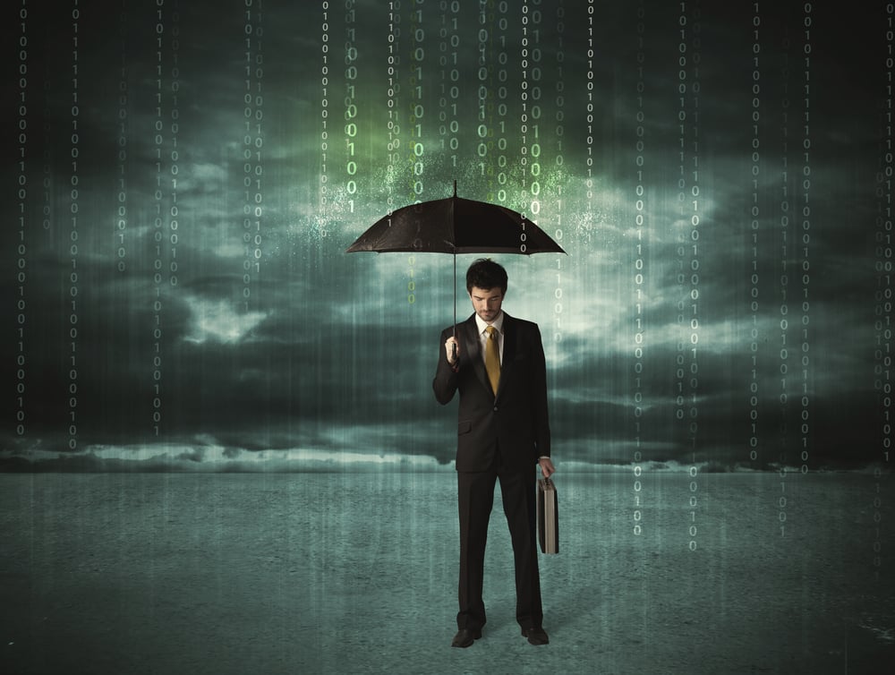 Businessman holding an umbrella to block a rainstorm of data, symbolizing the blocking of data access in intermittent-encryption ransomware attacks