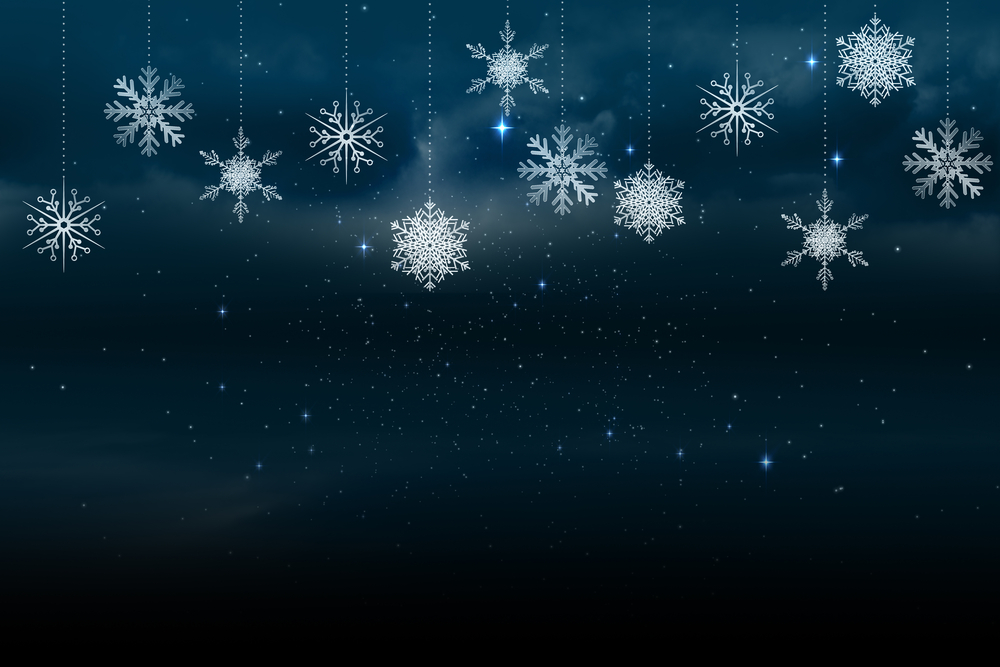 Snowflakes hanging in front of a dark blue sky for our winter holiday blog post, A Cybersecurity Carol: Cyberattacks Past, Present, and Future