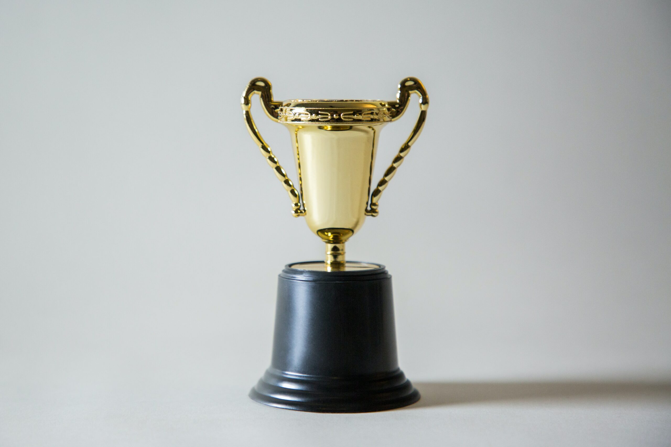 A golden trophy on a plain background