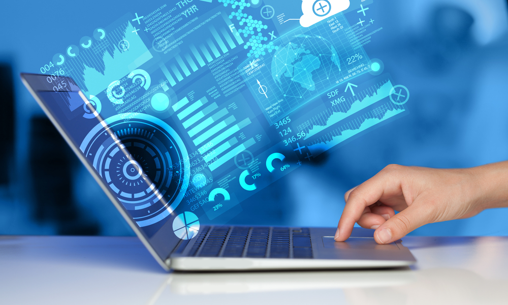 Side view of a laptop with digital charts and graphs projected in the air in front of the screen to signify data theft for our guide to data exfiltration