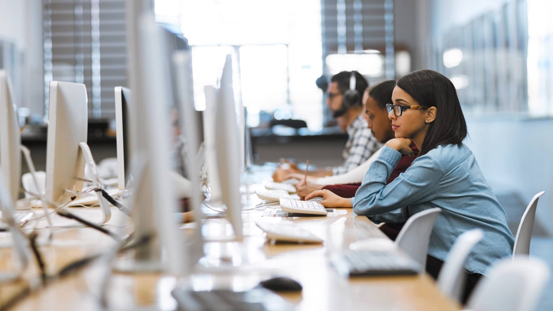 Shot of a group of university students working on computers in the library on campus.
