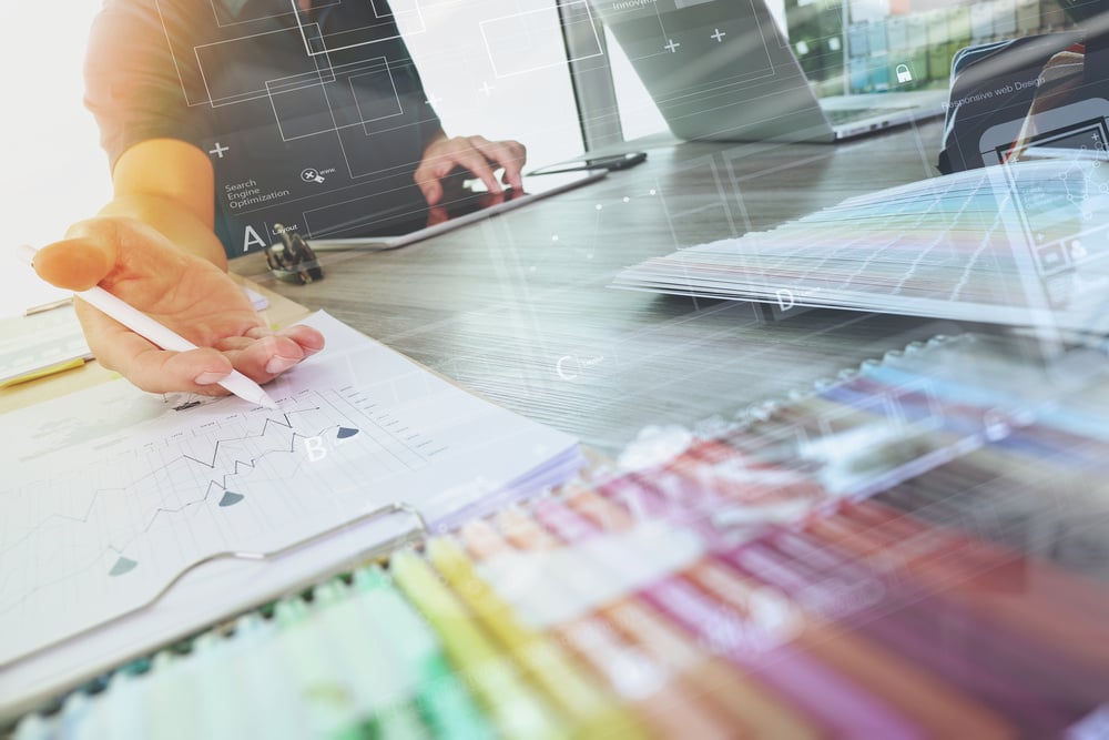 Laptop and colorful digital design diagram on a desk to signify cyberstorage and data security